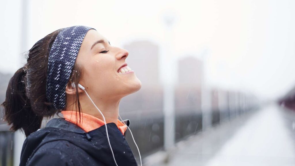 Woman exercising, happy smile after accomplishing a good run