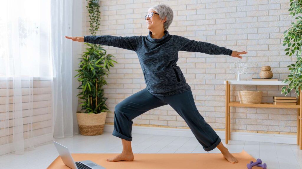 warrior pose by elderly lady. warrior pose is not recommended for yoga poses for hip bursitis relief