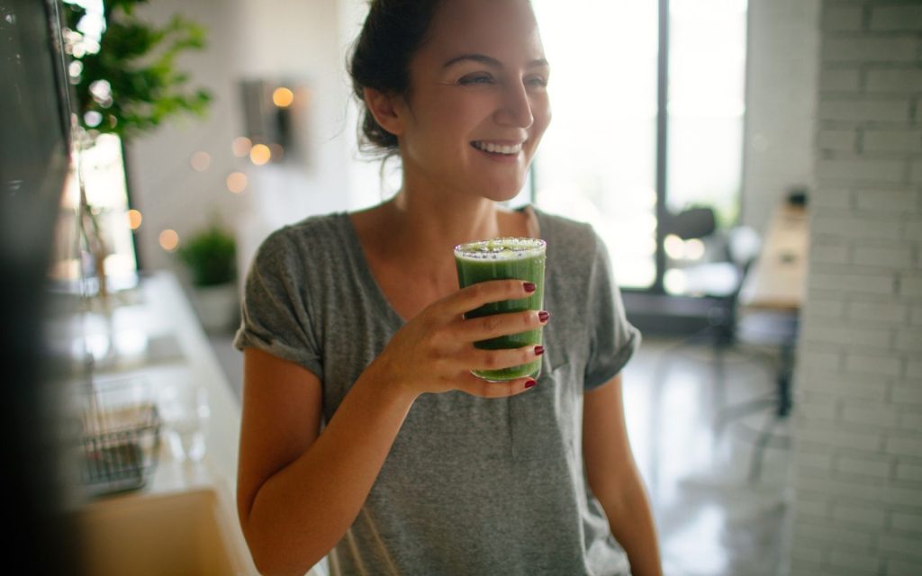Woman drinking healthy green smoothie. 5 healthy habits to improve your life